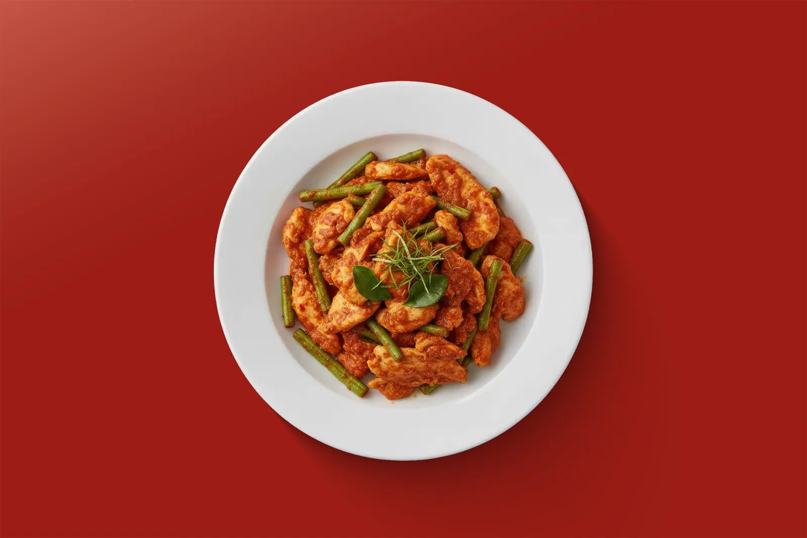Spicy chicken stir-fry with green beans on a plate